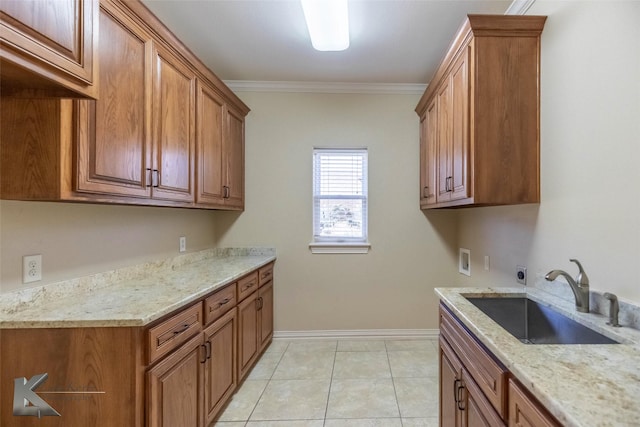 kitchen featuring ornamental molding, brown cabinetry, light tile patterned flooring, and a sink