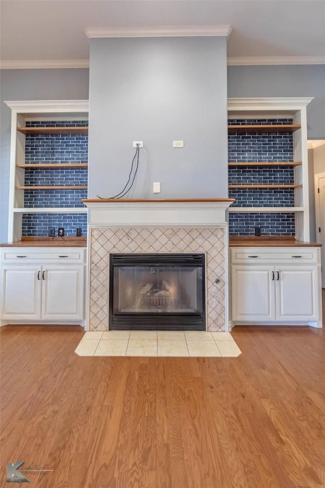 details with wood finished floors, a fireplace, and ornamental molding