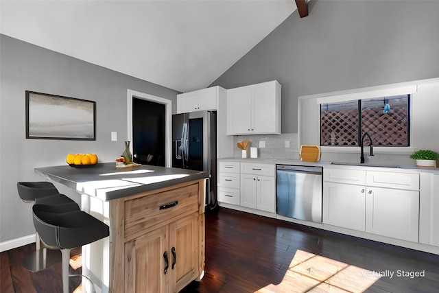 kitchen with black fridge with ice dispenser, dark wood-style floors, backsplash, stainless steel dishwasher, and a sink