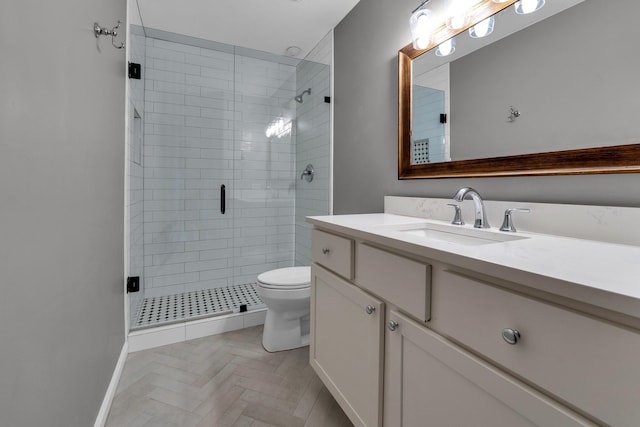 full bathroom with a stall shower, vanity, toilet, and baseboards