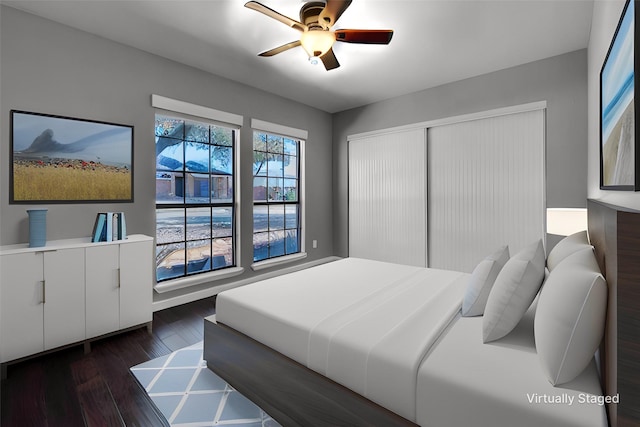 bedroom with ceiling fan, a closet, and dark wood-type flooring