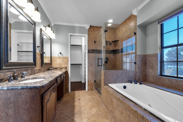 bathroom featuring a garden tub, crown molding, tile walls, a shower stall, and vanity