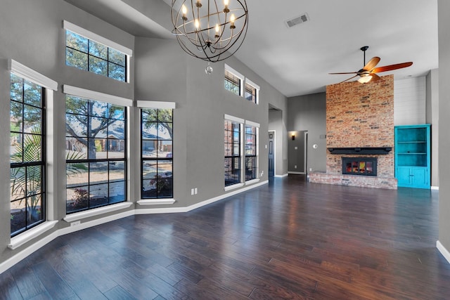 unfurnished living room with baseboards, a fireplace, visible vents, and wood finished floors