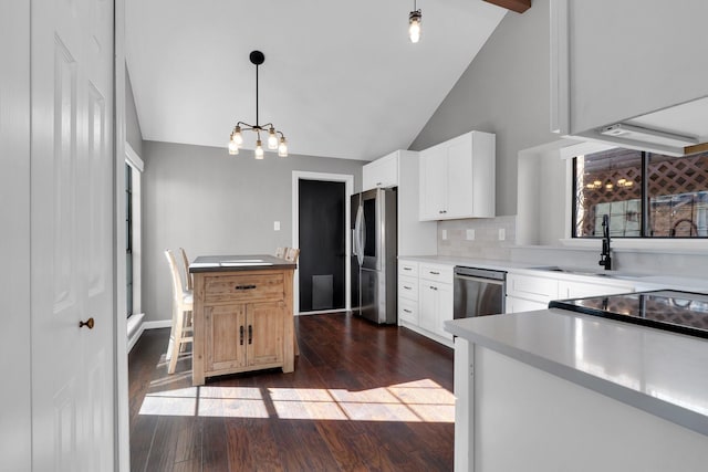 kitchen featuring stainless steel appliances, dark wood-style flooring, white cabinetry, and a sink