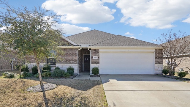 ranch-style house featuring driveway, brick siding, an attached garage, and a shingled roof