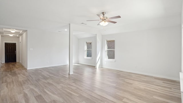 unfurnished room featuring light wood finished floors, ceiling fan, visible vents, and baseboards