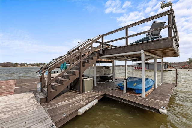 dock area with a water view, stairway, and boat lift