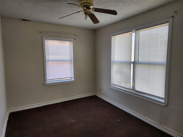 unfurnished room with a ceiling fan, baseboards, and a textured ceiling