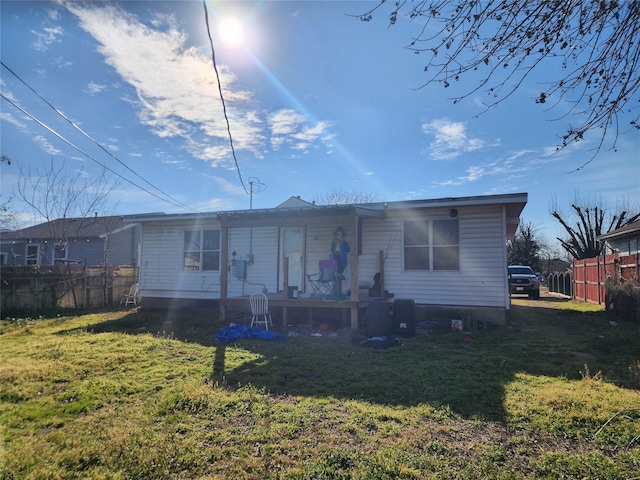 view of front of property with fence and a front lawn