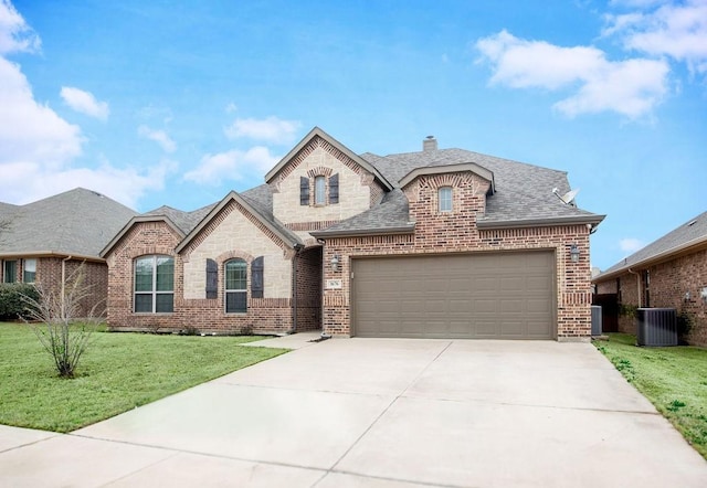 french country inspired facade with a front lawn, an attached garage, brick siding, and roof with shingles