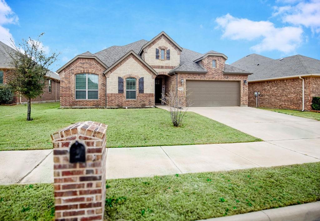 1676 Laramie Ln, Burleson, TX 76028 - french provincial home with a front yard, a garage, concrete driveway, brick siding, and roof with shingles