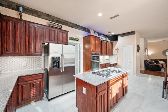 kitchen with marble finish floor, tasteful backsplash, visible vents, appliances with stainless steel finishes, and light stone countertops