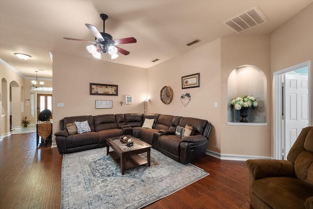 living room with baseboards, visible vents, and dark wood-type flooring