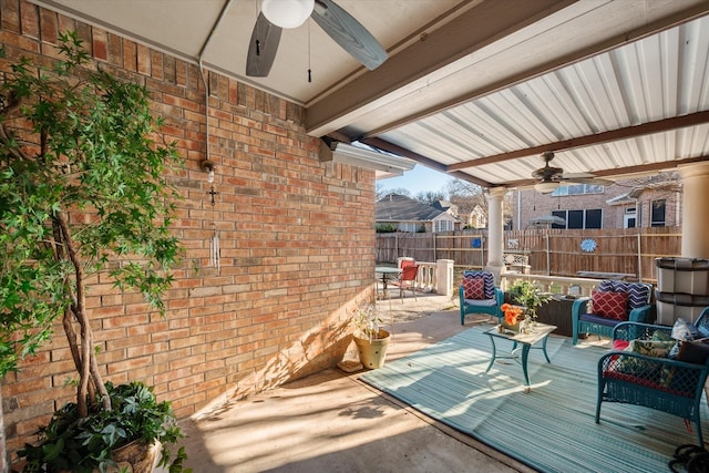 view of patio / terrace with a ceiling fan and fence