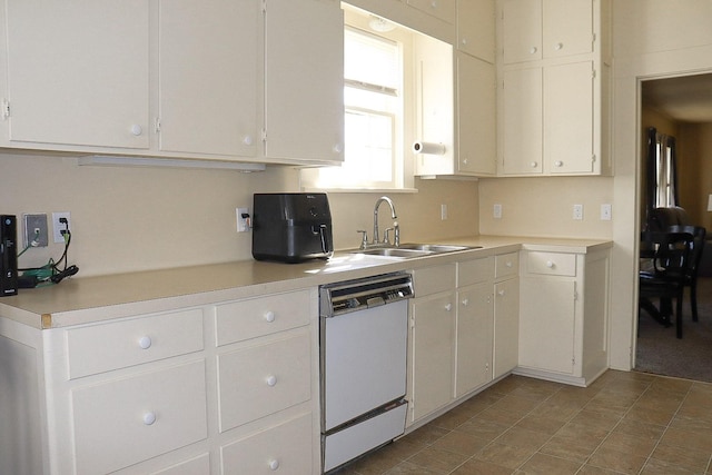 kitchen with light countertops, dishwasher, and a sink