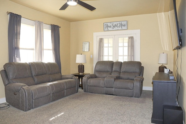 living room with french doors, carpet flooring, a ceiling fan, and a healthy amount of sunlight