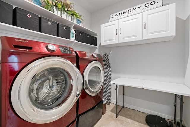 laundry room featuring cabinet space, baseboards, and washer and dryer