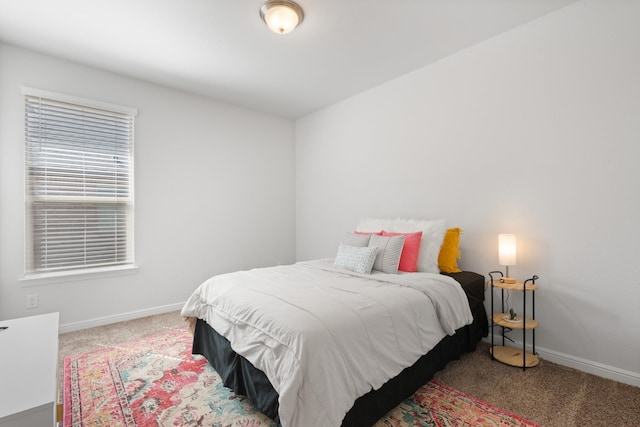 bedroom featuring carpet and baseboards