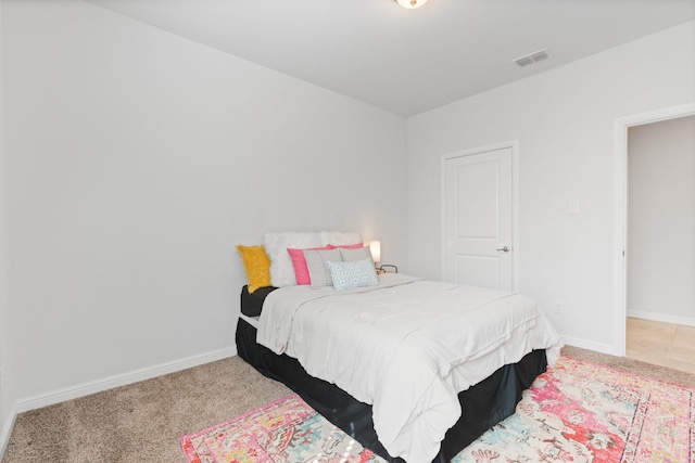 carpeted bedroom featuring visible vents and baseboards