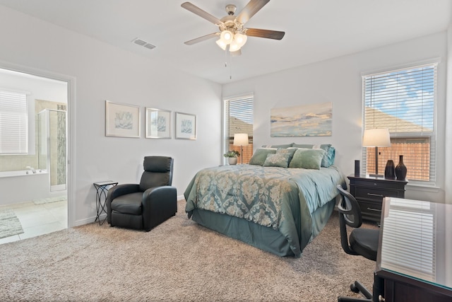 bedroom featuring baseboards, visible vents, ensuite bath, ceiling fan, and carpet flooring