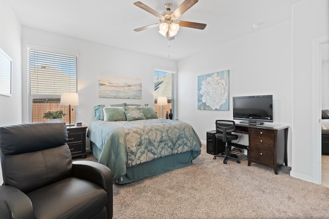 carpeted bedroom with a ceiling fan and baseboards