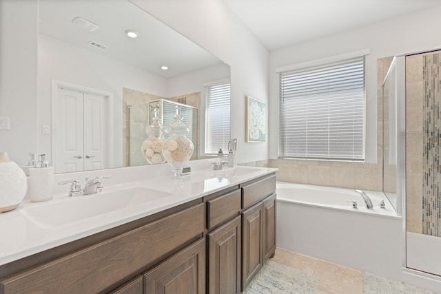 bathroom featuring a garden tub, double vanity, a stall shower, and a sink