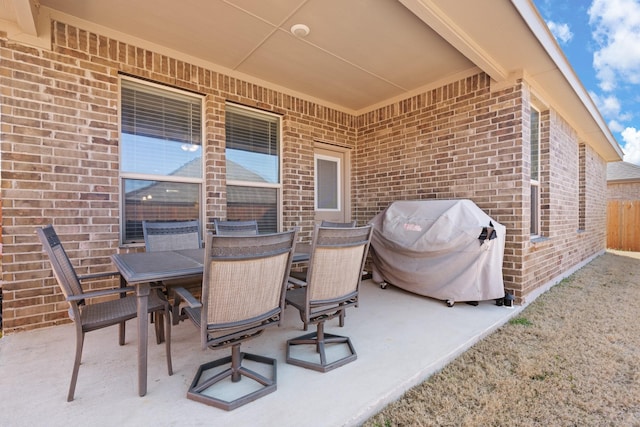 view of patio with outdoor dining area and grilling area