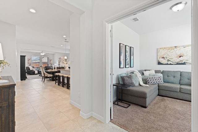 living area with light tile patterned floors, recessed lighting, visible vents, ceiling fan, and baseboards