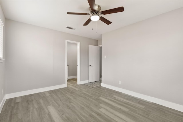 unfurnished bedroom featuring light wood-style flooring, visible vents, and baseboards