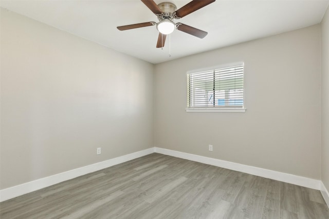 unfurnished room with light wood finished floors, ceiling fan, and baseboards