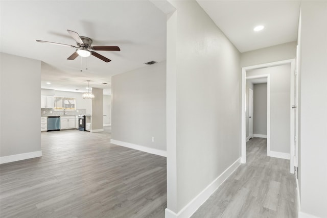 hall with a notable chandelier, recessed lighting, visible vents, light wood-type flooring, and baseboards