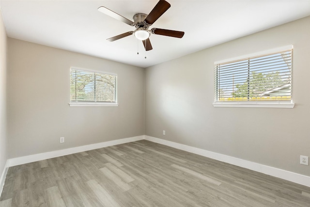 unfurnished room with ceiling fan, baseboards, and wood finished floors