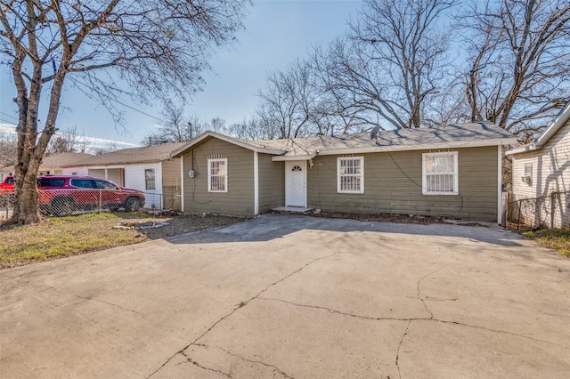 view of front of home with driveway and fence