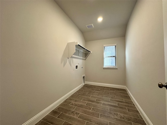 washroom with hookup for a washing machine, hookup for an electric dryer, laundry area, baseboards, and wood tiled floor