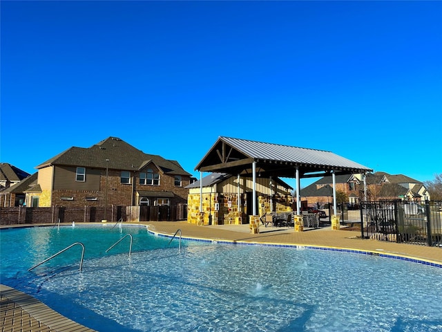 pool featuring fence and a gazebo