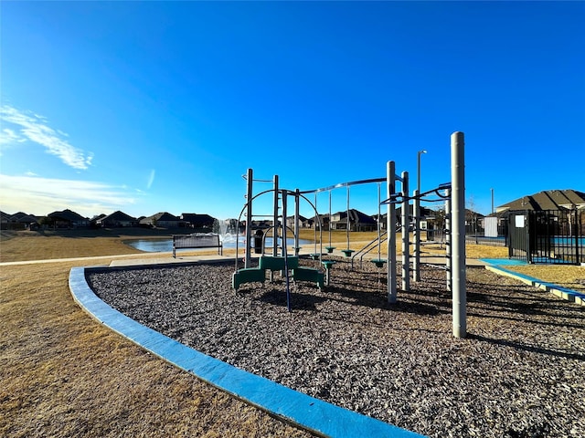 community jungle gym with a lawn