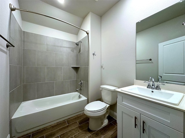 full bath featuring toilet, wood finish floors, vanity, baseboards, and shower / bathing tub combination