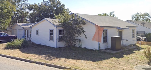 view of property exterior featuring fence and a lawn