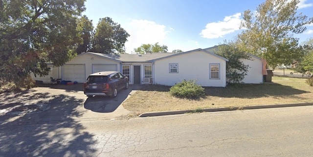 ranch-style home with driveway and an attached garage