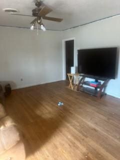 living area featuring a ceiling fan and wood finished floors