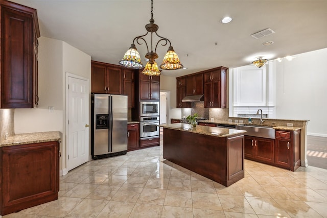 kitchen with tasteful backsplash, visible vents, appliances with stainless steel finishes, dark brown cabinets, and a sink