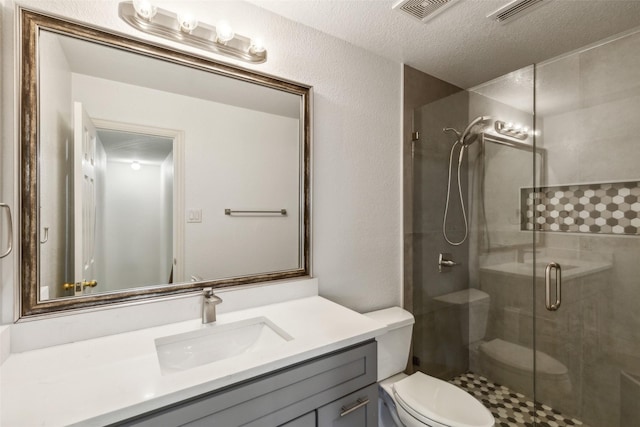 bathroom with toilet, a shower stall, visible vents, and vanity