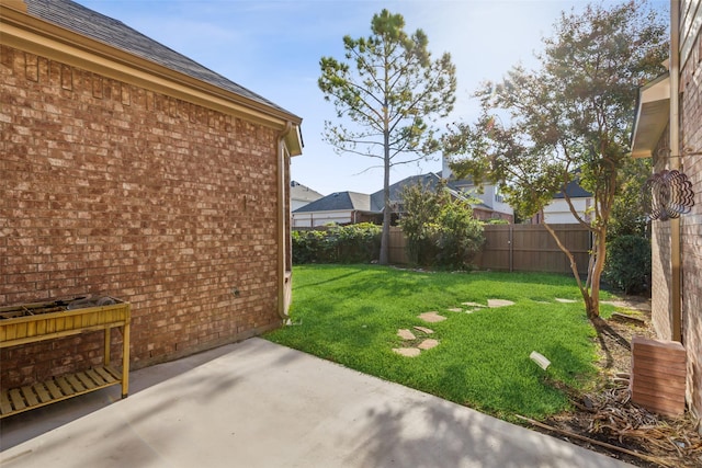 view of yard with a fenced backyard and a patio