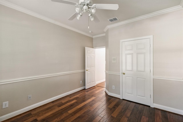 unfurnished bedroom featuring baseboards, visible vents, a ceiling fan, ornamental molding, and dark wood-style flooring