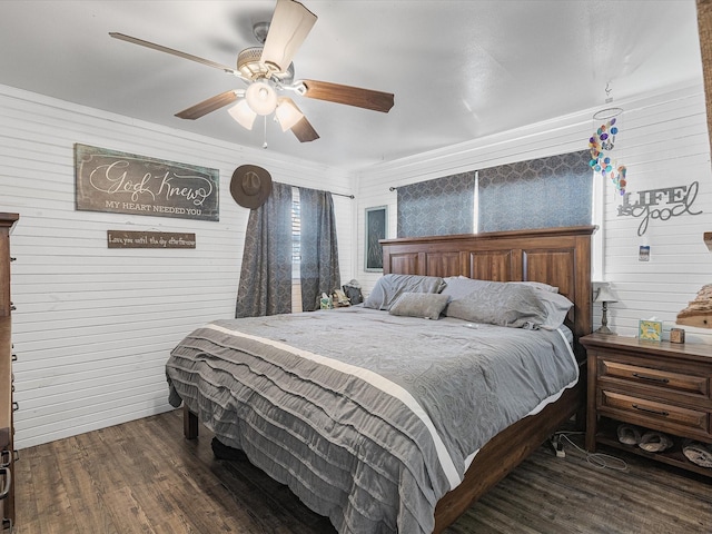 bedroom with a ceiling fan and dark wood-style flooring