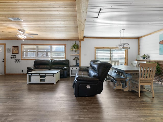 living area featuring a ceiling fan, visible vents, and wood finished floors