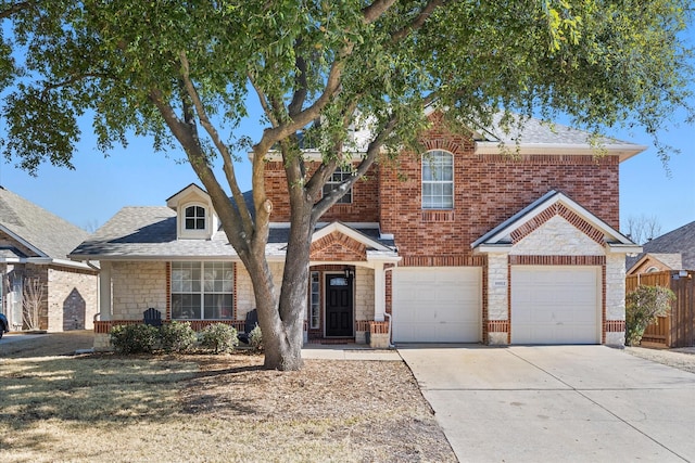 traditional-style home with a garage, driveway, and brick siding