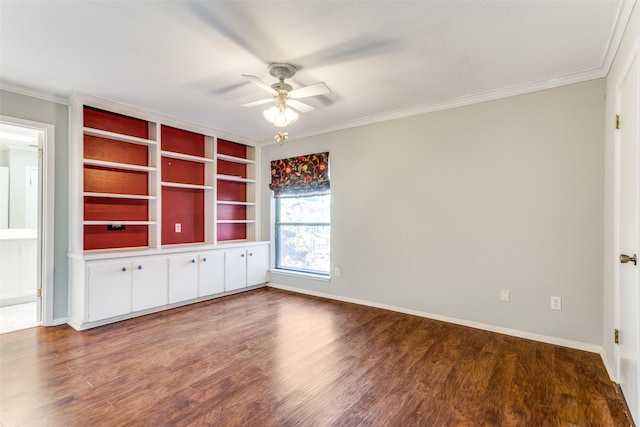 empty room featuring baseboards, ceiling fan, ornamental molding, and wood finished floors