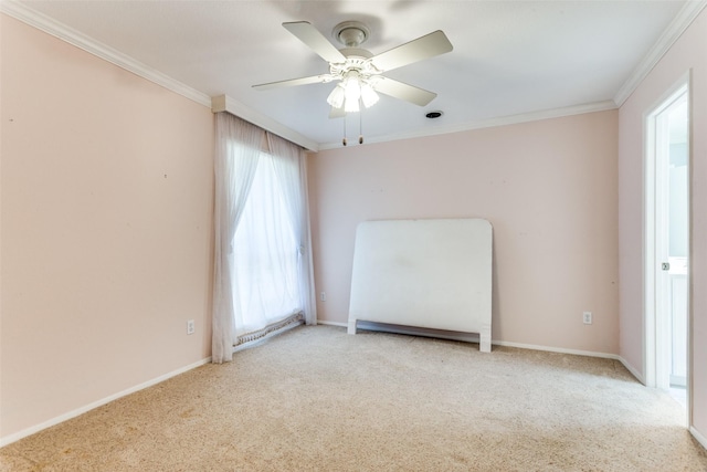 empty room featuring baseboards, carpet, ornamental molding, and a ceiling fan