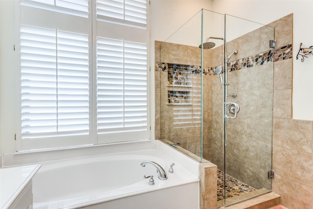 bathroom featuring a stall shower and a garden tub